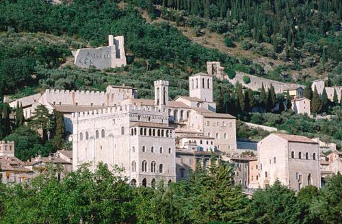 a large white building on top of a mountain at La Dimora di Pietra in Gubbio