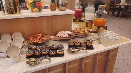 a buffet with many different types of donuts on a counter at Anantam Resort & Spa in Kasauli