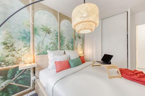 a bedroom with a bed with a laptop on it at Green place Disneyland Paris in Bussy-Saint-Georges