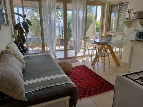 a living room with a couch and a table at פשוט מים. יחידה קסומה עם נוף מרהיב ובריכה מחוממת in Gonen