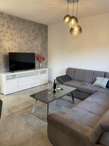 a living room with a couch and a table at Apartman Jurišić in Posušje