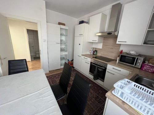 a kitchen with white cabinets and a counter top at Helle Wohnung in Linzer-Mitte in Linz