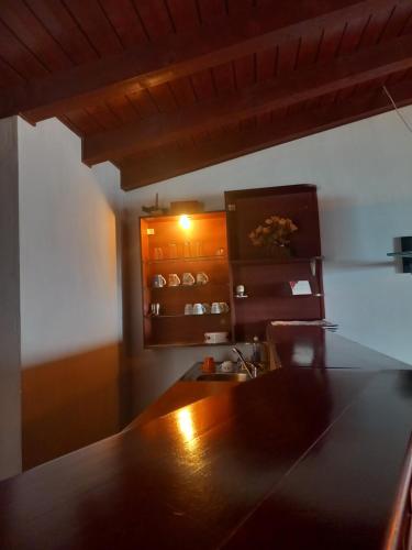 a kitchen with a wooden table and a sink at Villa Renesans in Star Dojran