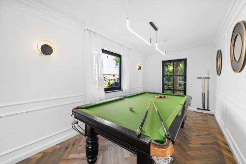 a pool table in a room with white walls at Villa Chou Chou in Steinhaus am Semmering