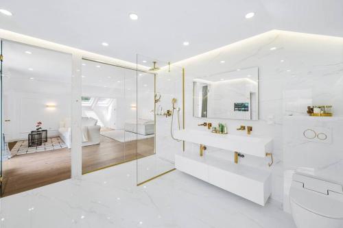 a white bathroom with a shower and a sink at Villa Chou Chou in Steinhaus am Semmering