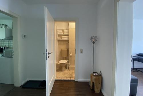 a hallway with a bathroom with a toilet in a room at Private Apartment in Hannover