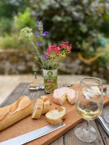 - une table en bois avec du pain et un verre de vin dans l'établissement Wijndomein Lalande La Tour, à Veyrines-de-Domme