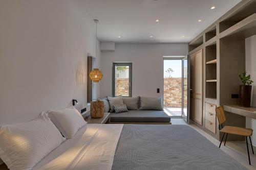 a living room with a bed and a couch at Clementina Paros in Naousa