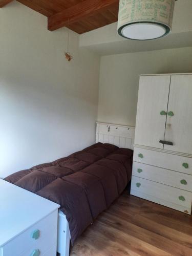 a bedroom with a bed and a dresser in it at Pacha Home By A.M.A in San Carlos de Bariloche