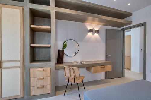 a bedroom with a desk and a mirror and a bed at Clementina Paros in Naousa
