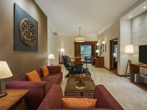 a living room with a couch and a table at Angsana Oasis Spa & Resort in Yelahanka
