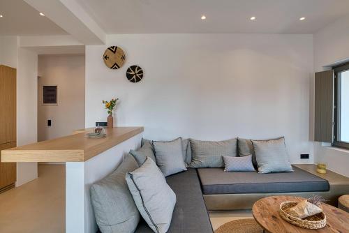 a living room with a couch and a table at Clementina Paros in Naousa