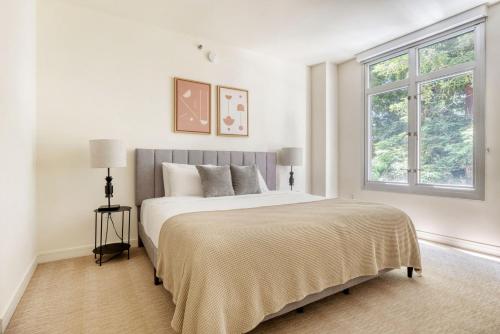a white bedroom with a large bed and a window at Mountain View 2br w bbq lounge roof nr shops SFO-1417 in Los Altos