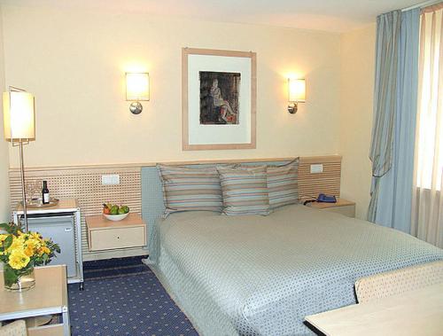 a hotel room with a large bed in a room at City Hotel in Schopfheim