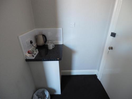 a small kitchen with a counter in a room at Richmond House in Southport