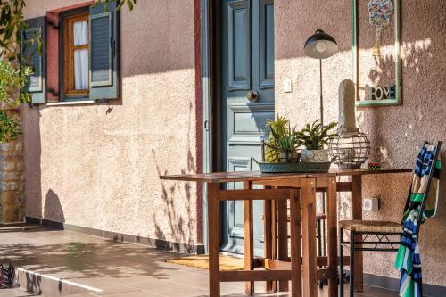 a table and chairs on a patio with a door at Malsova-Home in Kotrónion