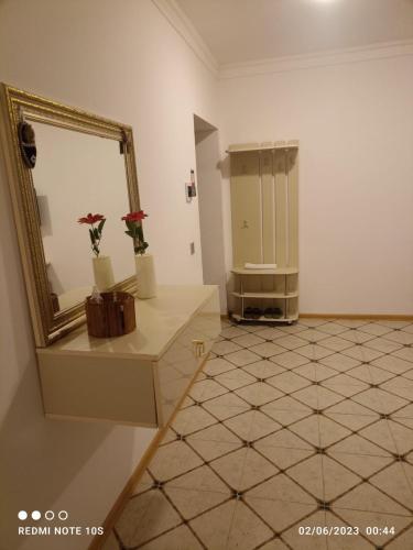 a bathroom with a mirror and a tiled floor at Hamzalli Garden in Gabala