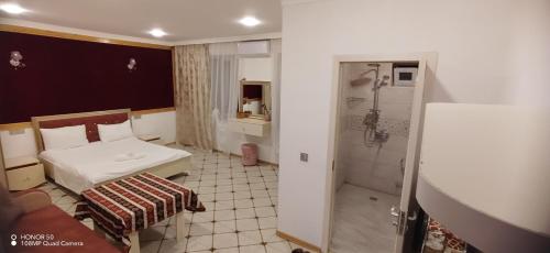 a small bathroom with a toilet and a shower at Hamzalli Garden in Gabala