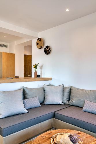 a living room with a couch and a table at Clementina Paros in Naousa