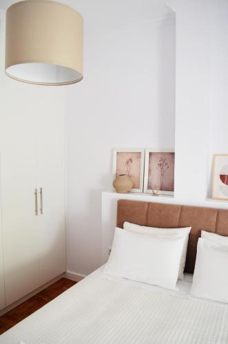 a bedroom with white walls and a bed with white pillows at Plaka athens 1 bedroom 4 persons apartment by MPS in Athens