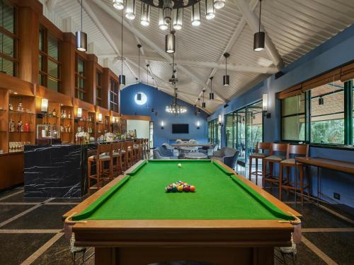 a pool table in a room with a bar at Angsana Oasis Spa & Resort in Yelahanka