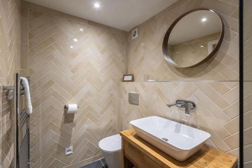 a bathroom with a sink and a mirror at Green End Farm Cottages The Stables in Goathland