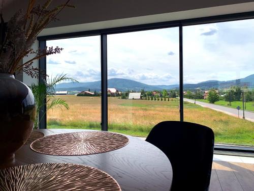 a dining table with a view of the mountains at Apartament 106 in Andrychów