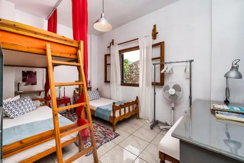 a bedroom with two bunk beds and a desk at Malsova-Home in Kotrónion