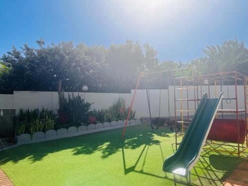 a playground with a slide in a yard at Santana 804 Beachfront Apartment with spectacular sea views in Margate