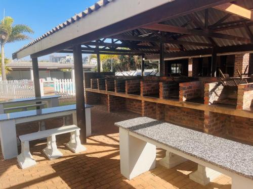 a group of benches sitting under a pavilion at Santana 804 Beachfront Apartment with spectacular sea views in Margate