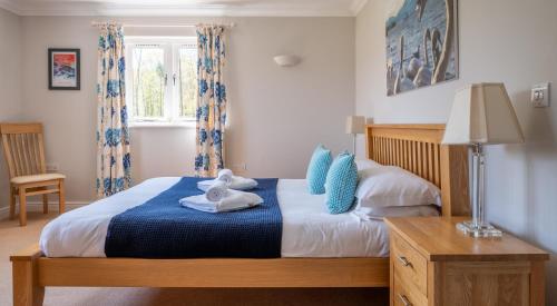 a bedroom with a bed with towels on it at Cunsey Lodge in Far Sawrey