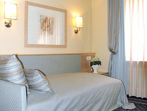 a bedroom with a large bed and a window at City Hotel in Schopfheim