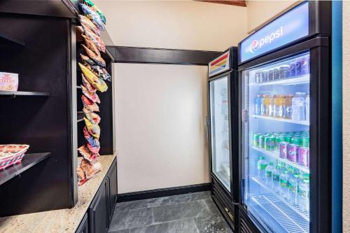 a refrigerator filled with lots of drinks in a store at Wingate by Wyndham Houston Bush Intercontinental Airport in Houston