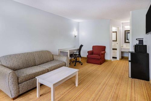 a living room with a couch and a chair at Days Inn & Suites by Wyndham Colonial in Williamsburg