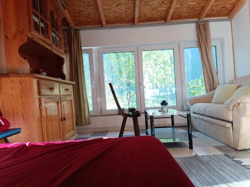 a living room with a couch and a table at Robinson Haus PanoramA No Electricity in Zagvozd