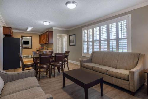 a living room with a couch and a dining room at The Sandbar Hotel, Trademark Collection by Wyndham in Myrtle Beach