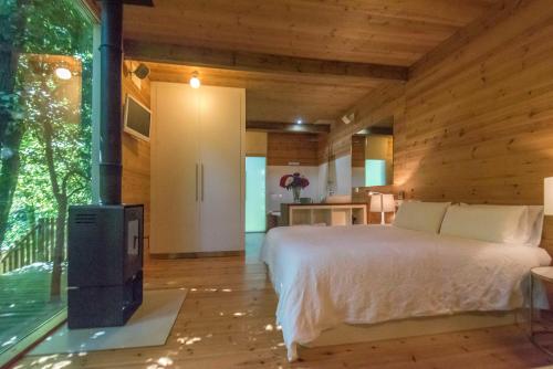 a bedroom with a bed and a fireplace in a room at Cabanas de Apriscos in A Coruña