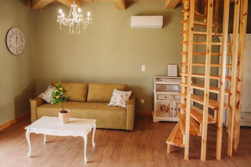 a living room with a couch and a table at OSADA LEŚNA - domki z basenem in Stare Miasto