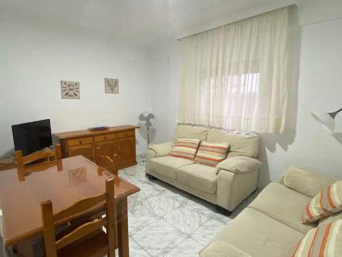 a living room with a couch and a table at Cozy Apartment in Chiclana City Center by Chiclana Dreams in Chiclana de la Frontera