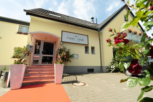 a building with a door and flowers in front of it at Jupa's Hotel in Düsseldorf