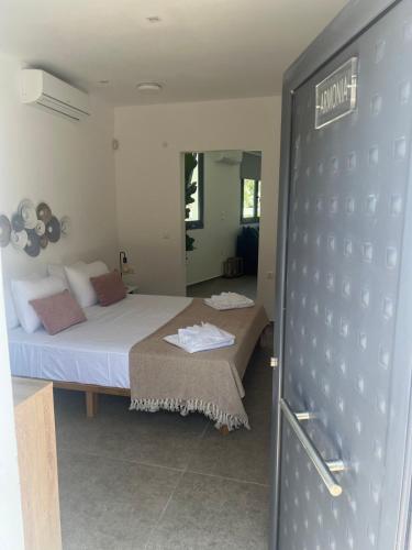 a bedroom with a bed and a sliding door at Mythos Luxury Villa-Skiathos in Troulos