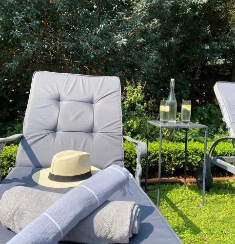 a hat sitting on a chair next to a table at Maison H Guest House in Durban