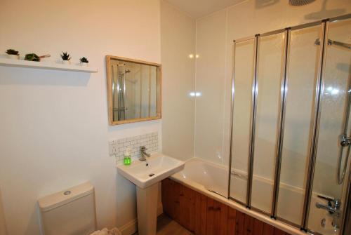 a bathroom with a sink and a shower and a toilet at May View in Pittenweem