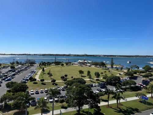 an aerial view of a parking lot next to the water at Ocean View Apartments at the heart of Gold Coast in Gold Coast