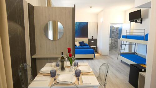 a room with a table and a room with a bunk bed at Hotel Beach in Tortoreto Lido