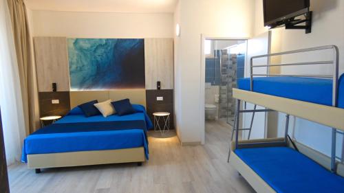 a bedroom with two bunk beds and a bathroom at Hotel Beach in Tortoreto Lido