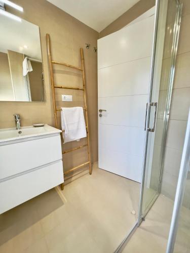 a bathroom with a sink and a shower at Balnea San Pedro in Mondariz-Balneario