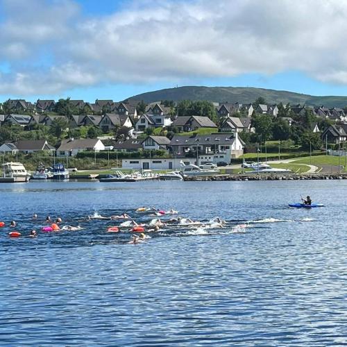 a group of people on a body of water at Leaba On The Lake in Killaloe