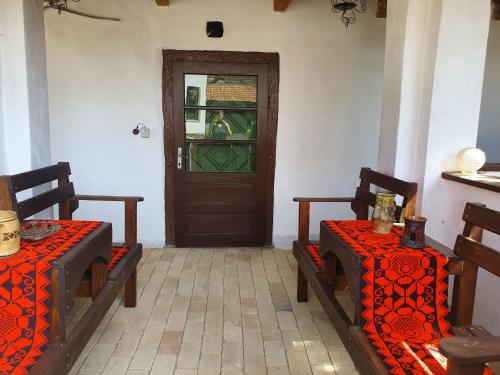 a room with two chairs and a door with a window at Pensiunea Aurelia in Şiria