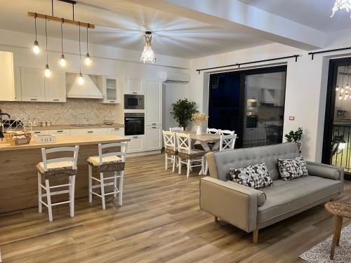 a living room and kitchen with a couch and a table at Al Vicolo Stretto in Brancaleone Marina